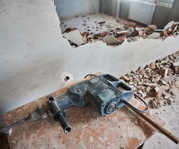 hammer-drill-on-wooden-table-in-apartment-under-re-2023-11-27-04-55-55-utc